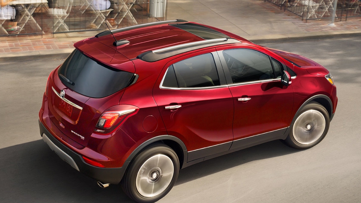 Red Buick driving on a city street